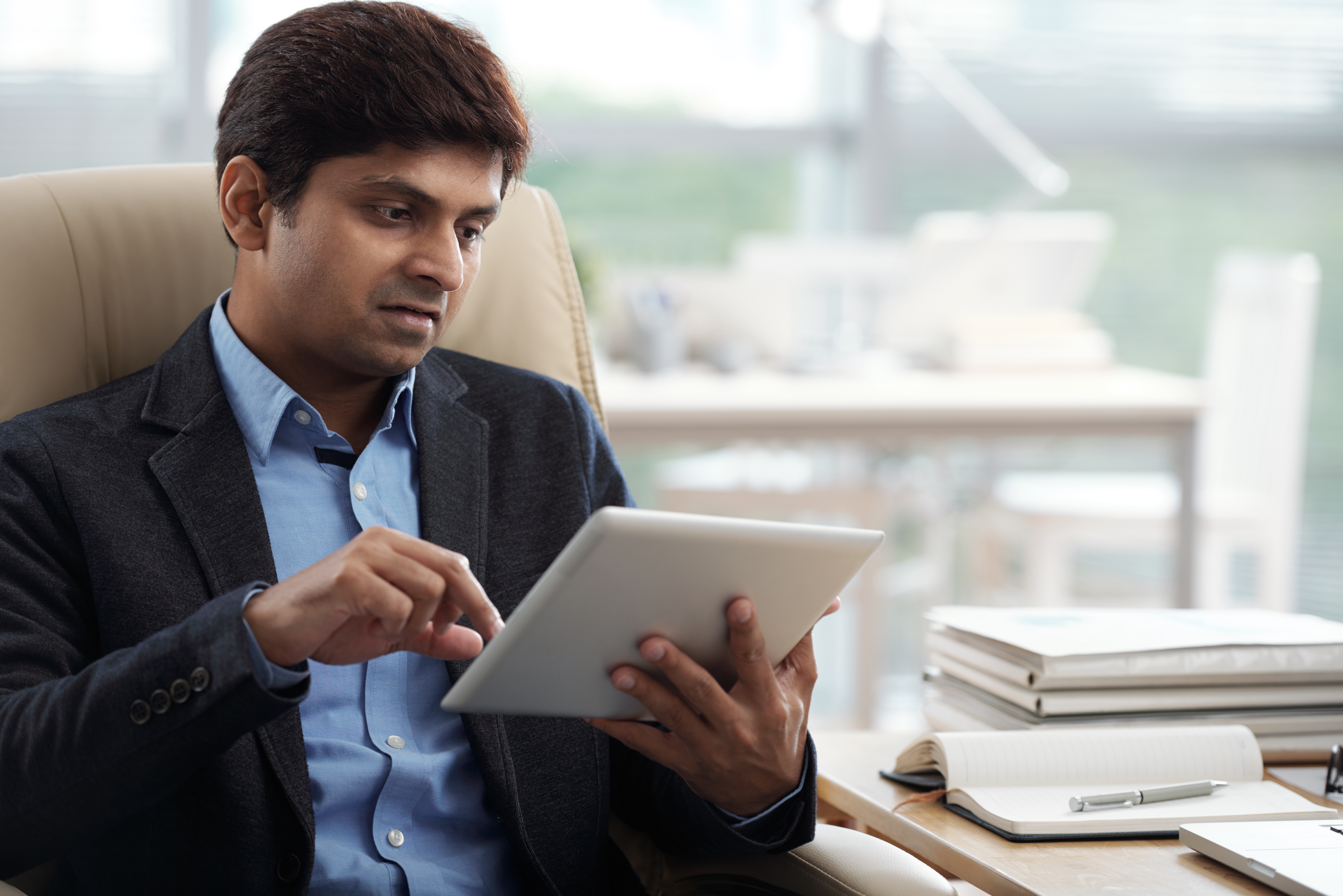 Businessman monitoring credit activity on digital tablet